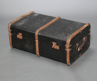 A black fibre bound and wooden cabin trunk with hinged lid 30cm x 76cm x 27cm (1 handle missing, 1 handle damaged, signs of old but treated worm)  
