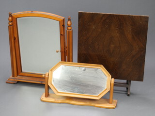 A 1930's walnut fire screen/folding table 64cm x 52cm, a Victorian style arched bevelled plate dressing table mirror in a pine frame 64cm x 59cm x 12cm and a lozenge shaped ditto (1 finial missing) 29cm h x 58cm w 