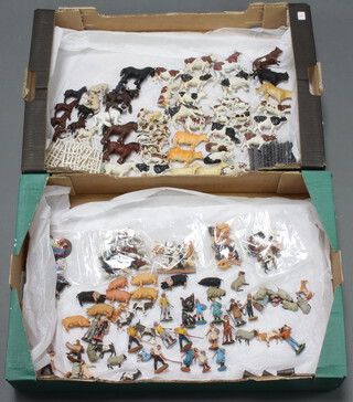 Two fruit trays containing Britains plastic farmyard animal figures