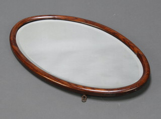 An oval bevelled plate wall mirror contained in an oak frame 36cm x 61cm (damaged to the side of the frame), a John Watts folding bed tray 70cm x 36cm, a mahogany twin handled tea tray 65cm x 37cm 