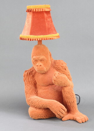 An orange table lamp in the form of a seated gorilla 37cm h x 30cm w x 23cm d 
