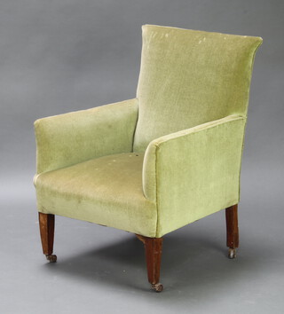 An Edwardian armchair upholstered in green material raised on square tapered supports 89cm h x 61cm w x 62cm d (30cm x 35cm, barn condition with tears in places)  