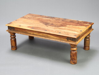 A rectangular Indian hardwood and metal bound coffee table raised on turned supports 39cm h x 111cm w x 60cm d 