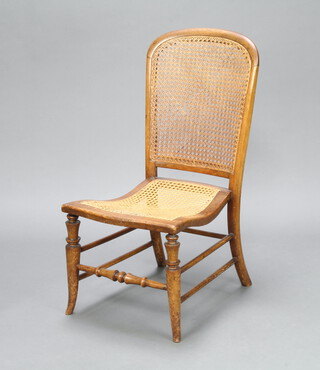 A Victorian mahogany framed nursing chair with woven cane seat and back, raised on turned supports 81cm h x 40cm w x 43cm d (some minor damage to the cane back) 