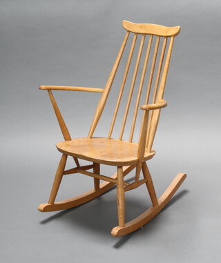 Ercol, a light elm stick and rail back rocking chair with Ercol sticker, base marked 42, 84cm h x 60cm w x 70cm d (seat 33cm x 27cm, light scratches, water stain to the seat and rockers)
