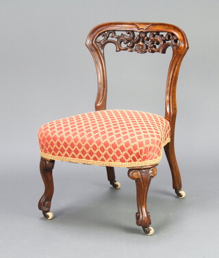 A Victorian carved and pierced mahogany nursing chair with overstuffed seat raised on cabriole supports 69cm h x 49cm w x 45cm (frame is loose) 