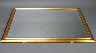 A bevelled plate wall mirror contained in a decorative gilt frame 158cm h x 123cm 