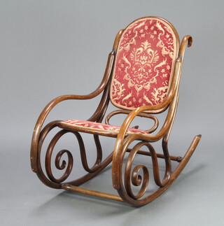 A Thonet style bentwood armchair, the seat and back upholstered in red and gold material 89cm h x 100cm w x 48cm (mark to right hand arm)