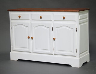 A pine and white painted dresser base fitted 3 drawers above triple cupboards 92cm h x 134cm w x 46cm d 