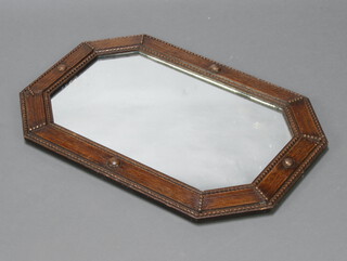 A lozenge shaped plate mirror contained in an oak frame 69cm h x 46cm w 
