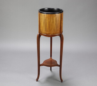 A circular Edwardian inlaid mahogany jardiniere with later plastic liner and shaped undertier, raised on cabriole supports 97cm h x 31cm diam. (2 panels are split, sunbleached, signs of old but treated worm)   
