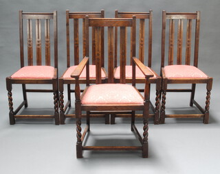 A set of 5 1930's oak stick and rail back dining chairs with upholstered drop in seats, raised on spiral turned supports 
