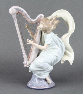 A Lladro figure of a harpist 6312 35cm (1 of the strings is missing)