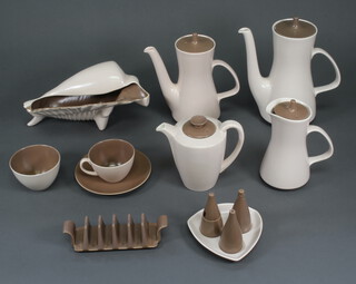 A vintage Poole Pottery Tan and Cream dinner, tea and coffee service comprising 9 coffee cups (3 a/f), 12 saucers (2 a/f), 20 tea cups (3 a/f), 18 saucers (7 a/f), 4 2 handled bowls (2 a/f), 6 saucers, 2 sugar bowls, large coffee pot (lid a/f), small coffee pot, 2 teapots (both a/f), hot water jug and cover, 4 vegetable dishes and covers (2 bases a/f), 2 dishes, sauce boat and stand, gravy boat and stand, 2 toast racks, 2 three piece condiments and stands, flower vase and a shell bowl 
