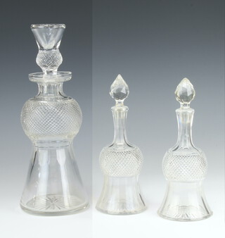 A thistle shaped decanter and stopper 30cm h, two spirit bottles of thistle from 20cm, h (1 spirit bottles has a chipped stopper, the other a slightly ground stopper)