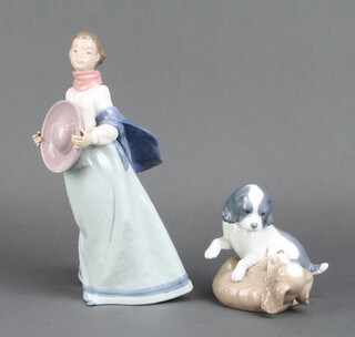 A Nao group of 2 puppies playing 13cm, ditto of a lady holding a hat 30cm 