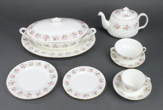 A Minton Spring Bouquet tea and dinner service comprising 6 tea cups, 6 saucers, 8 2 handled bowls, 8 saucers, teapot, milk jug, sugar bowl, 8 small plates, 8 medium plates, 8 dinner plates, 2 tureens and covers, serving plate, gravy boat and satnd 