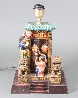 A 20th Century Chinese ceramic table lamp base with figures before a temple, converted to electricity 40cm 
