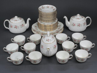A Minton Spring bouquet tea and dinner service comprising 12 tea cups, 13 saucers, 3 teapots and covers (1 pot cracked), 13 small plates, 2 large plates, 2 serving plates