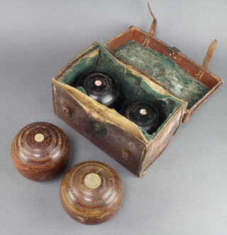 A pair of Jaques & Sons turned lignum vitae bowls marked 1503 5 1/16 Bias No 3, together with a pair of Jaques 4 3/4 ebonised bowling woods, Bias No 3 contained in a leather case (some wear to case) 