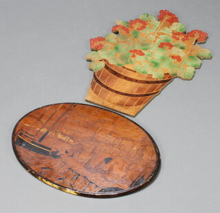 A 1930's Continental oval poker work plaque decorated fisherman 41cm x 61cm together with a painted wooden panel in the form of a barrel of flowers 65cm h x 50cm 
