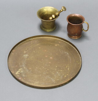 A 17th/18th Century style brass mortar and pestle 9cm x 10cm, a copper and brass tankard 10cm x 9cm and a circular brass dray 35cm diam. 