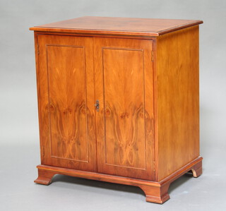 A Georgian style crossbanded yew cabinet enclosed by panelled doors, raised on bracket feet 86cm h x 76cm w x 53cm d (some minor contact marks) 