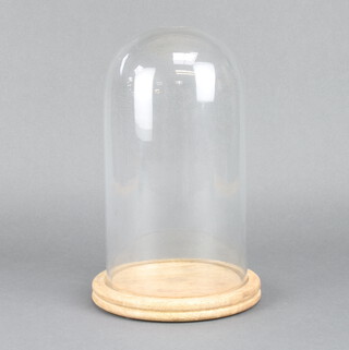 A glass dome 32cm on a wooden base 