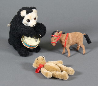 A clockwork figure of a panda playing a drum 17cm, a ditto of a plush donkey together with a Teddy Bear's Picnic bear 10cm 