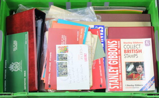 Various empty stamp albums, first day cover albums, stamp catalogues, contained in a green crate