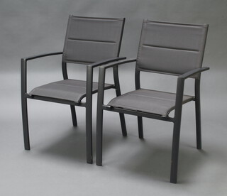 A pair of tubular metal stacking open arm chairs with fabric seats and backs 87cm h x 57cm w x 50cm d 