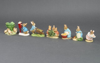 Seven World of Beatrix Potter composition figures - Appley Dapply, Flopsy, Mopsy & Cottontail, The Flopsy Bunnies, Mrs Rabbit with Robin, Peter Rabbit Posting a Letter, Cecily Parsley with Cowslips, and Peter Pushing Wheelbarrow 