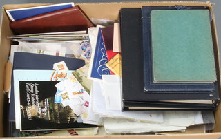 A quantity of GB stamps on paper, 2 ring bound albums, etc, in a brown cardboard box 