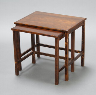 A nest of 2 1930's rectangular oak interfitting tables raised on square supports 46cm h x 52cm w x 39cm d 