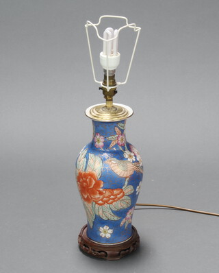 A Chinese porcelain table lamp decorative with flowers on a hardwood base 33cm 