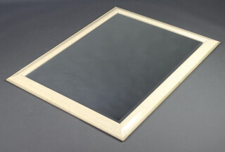 A rectangular bevelled plate mirror contained in a white marble effect frame 116cm x 90cm (some chips to frame) 
