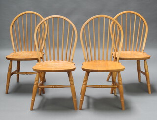A set of 4 beech framed stick and rail back dining chairs with solid seats and H framed stretchers 93cm h x 45cm w x 37cm d (seats 29cm x 33cm, some contact marks and water damage, 1 chair is missing an H framed stretcher) 