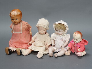 A box containing 4 plastic dolls 