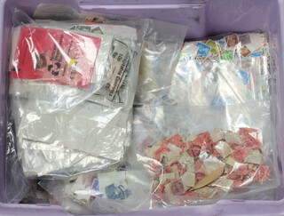 A quantity of loose used GB stamps in a purple box 