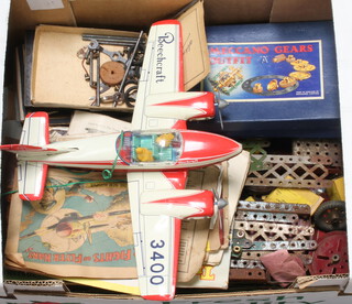A tinplate battery operated model aircraft marked Beechcraft and a small collection of Meccano 