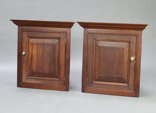 A pair of 19th Century mahogany hanging corner cabinets with moulded cornice, enclosed by panelled door 75cm h x 72cm w x 34cm d 