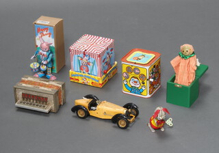 Two pressed metal Jack in the Boxes, a wooden ditto, child's accordion, 2 tinplate clockwork figures of rabbits and a model vintage car