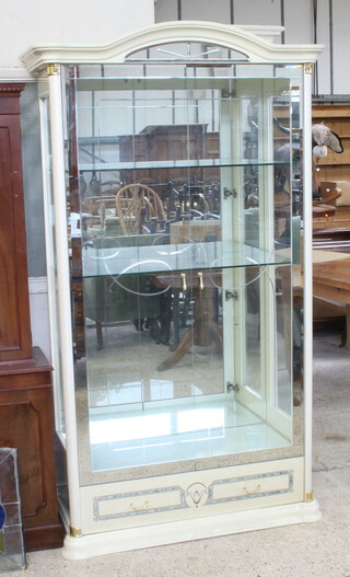 A large and impressive white laminate display cabinet with mirrored back fitted adjustable shelves enclosed by cut glass panelled doors, the base fitted a drawer 200cm h x 115cm w x 51cm d 