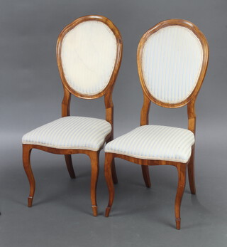 A pair of Biedermeier style show frame spoon back dining chairs, seats and backs upholstered in striped material, raised on cabriole supports 100cm h x 44cm w x 42cm d (seats 24cm x 27cm, light stains to the upholstery, 1 missing a section of veneer to the back)