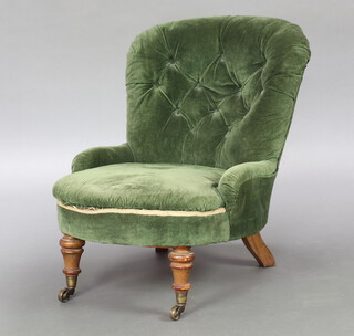 A Victorian metal framed nursing chair upholstered in green buttoned material, raised on turned supports 64cm h x 56cm w x 55cm d (seat 32cm x 37cm) 