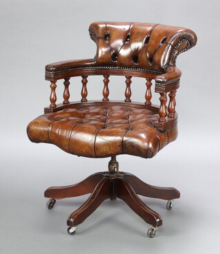 A Captain's style revolving tub back office chair with bobbin turned decoration, upholstered in brown material 85cm h x 64cm w x 58cm d (seat 36cm x 38cm) 