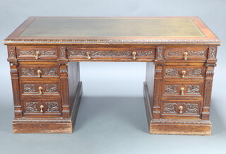 Shoolbred, a Victorian carved oak desk with green leather inset writing surface above 1 long and 8 short drawers, the top left hand drawer numbered 2481 73cm h x 155cm w x 83cm d 

