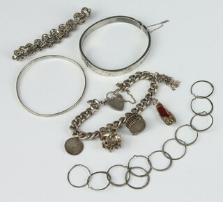 A silver charm bracelet and minor silver jewellery 87 grams 