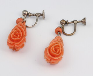 A pair of silver and carved coral floral ear clips 