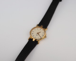 A lady's gilt cased Gucci wrist watch 20mm on a black leather strap 